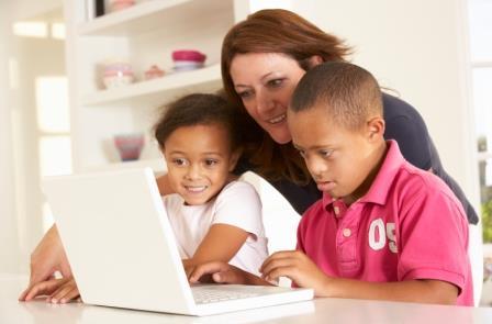 Mother and Downs Syndrome son with laptop